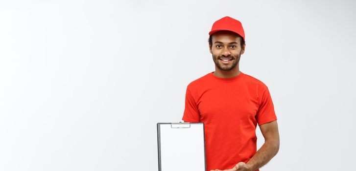 Delivery Concept - Portrait of Handsome African American delivery man or courier showing a confirmation document form to sign. Isolated on Grey studio Background. Copy Space