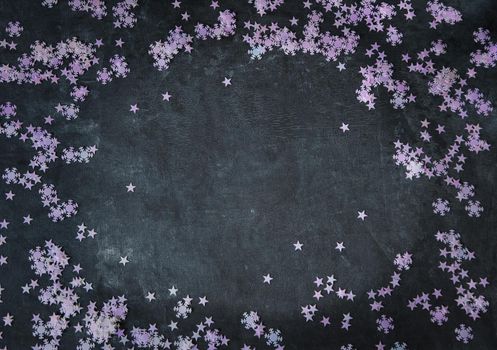 christmas background, confetti snowflakes and stars are scattered over a dark gray background. High quality photo