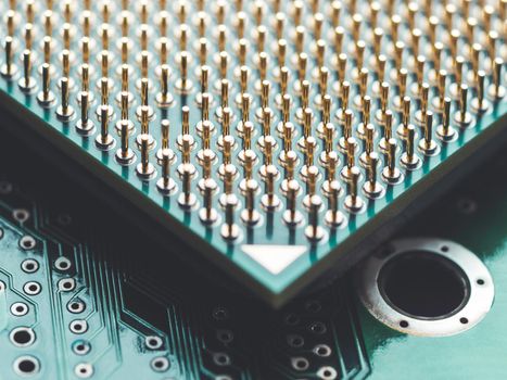 Macro photo of hard disk controller board and Central Computer Processor. CPU on green background. IT detail in computer. Technological detail of personal computer.