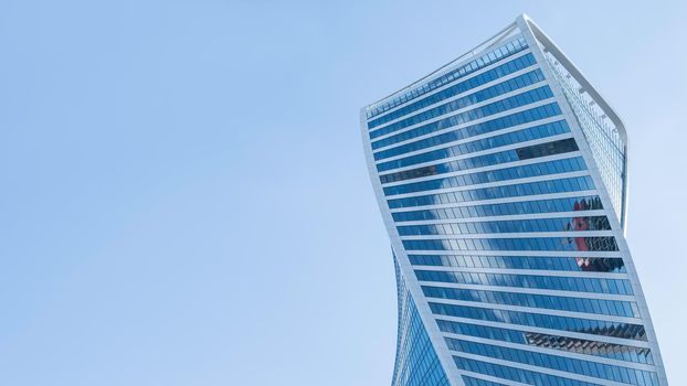 MOSCOW, RUSSIA - September 18, 2021. Evolution tower of Moscow International Business Center MIBC on clear blue sky background. Banner with copy space.