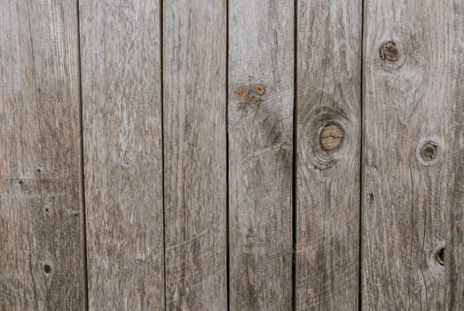 old shabby gray fence made of wooden boards. background texture wall