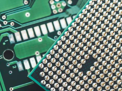 Macro photo of hard disk controller board and Central Computer Processor. CPU on green background. IT detail in computer. Technological detail of personal computer.