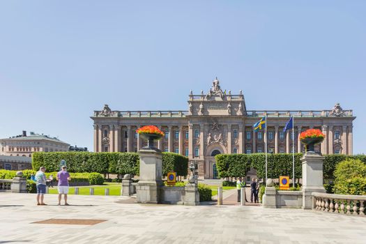 STOCKHOLM, SWEDEN - July 06, 2017. Tourists near Parliament House, seat of parliament of Sweden, the Riksdag.