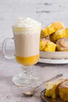pumpkin cinnabons and latte for dessert, holiday table with pastries, home sweet home, autumn menu. High quality photo
