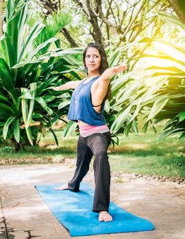 A girl doing flexibility yoga, Woman doing yoga outdoors, young girl showing yoga styles outdoors, yoga and fitness concept