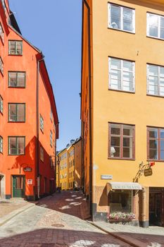 STOCKHOLM, SWEDEN - July 06, 2017. Tourists walk on narrow streets in historic part of town. Old fashioned buildings in Gamla stan.