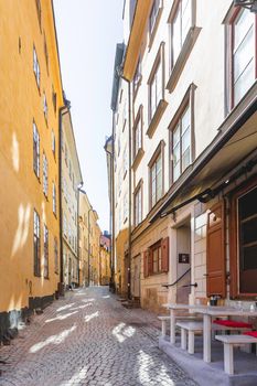 STOCKHOLM, SWEDEN - July 06, 2017. Bright sun reflections on narrow street in historic part of Stockholm. Old fashioned building in Gamla stan, old part of town.