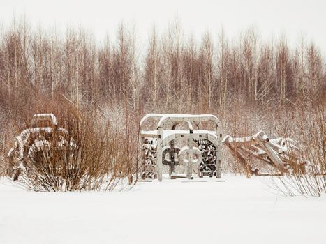 NIKOLA-LENIVETS, RUSSIA - January 15, 2017. Wooden art object, exhibit of architectural festival Archstoyanie. Winter cloudy day.