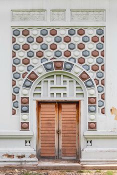 BANGKOK, THAILAND - October 23, 2012. Wooden doors of Clock tower in Lumpini park. Ornamental building with architectural decorations in urban recreational park.