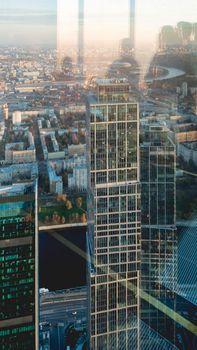 MOSCOW, RUSSIA - October 07, 2021. Panorama view from skyscraper of Moscow-city business center. Silhouettes of people on window glass.