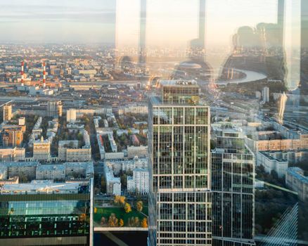 MOSCOW, RUSSIA - October 07, 2021. Panorama view from skyscraper of Moscow-city business center. Silhouettes of people on window glass.