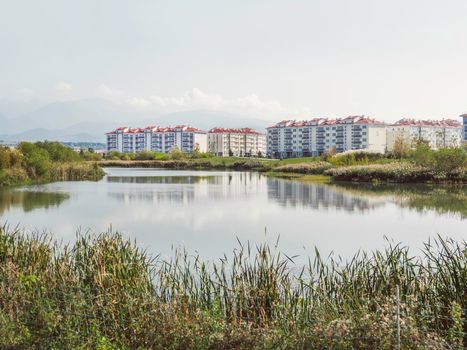 Low - rise apartment buildings in new neighbourhood. Quarters of newly built houses for sale. Adler district of Sochi, Russia.