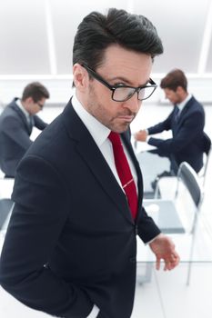 close up.serious boss standing in the conference room.business concept