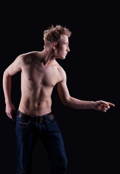 Young naked man in jeans look at light