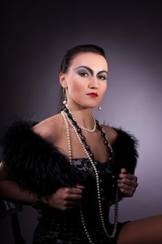 Young woman in fur boa with pearl beads retro syle