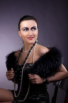 woman smile in fur boa and pearl beads retro makeup