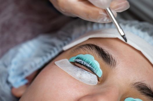 Close-up portrait of a woman on eyelash lamination procedure