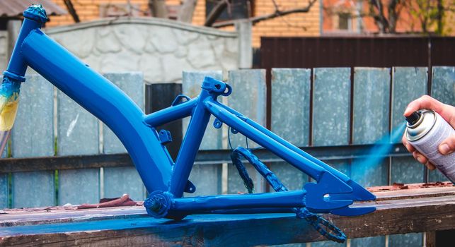 father paints a bicycle for a child. selective focus