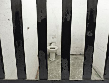 alcatraz cell with bars and hygienic sanitary ware