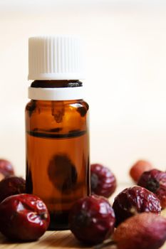 Rosehip seed essential oil in a small bottle. Selective focus.Na