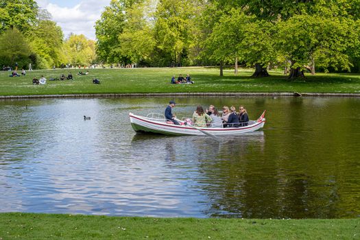 Frederiksberg, Denmark - May 07, 2022: People in a rowboat in Frederiksberg Gardens.
