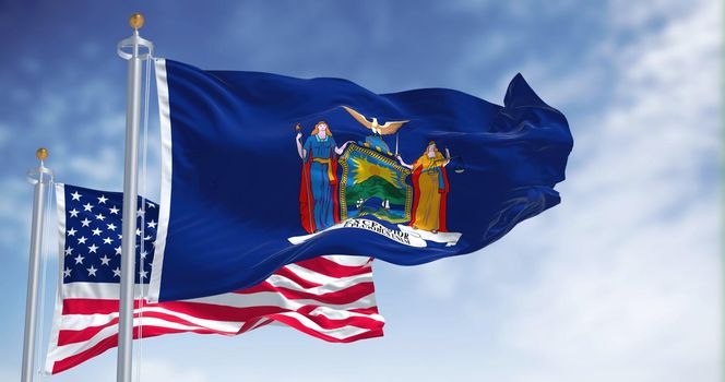 The New York state flag waving along with the national flag of the United States of America. In the background there is a clear sky. New York is a state in the Northeastern United States