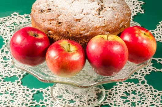 Applesauce raisin rum cake for christmas table. Table decorated with lacy snowflakes and napkin. From series of "Merry Christmas"