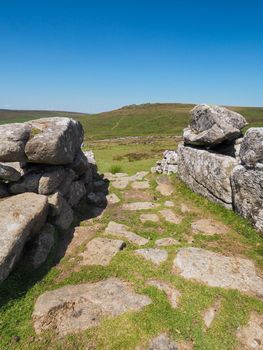 Entrance stones to the prehistoric settlement of Grimspound sitting under Hookney Tor and Hameldown, Dartmoor National Park, Devon, UK