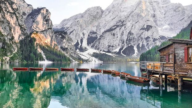 Lake Braies with floating boats and snow-capped mountains