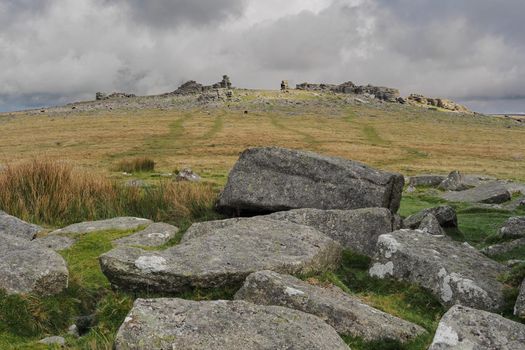 Looking up to Great Staple Tor from Middle Staple Tor under cloudy sky, Dartmoor National Park, Devon, UK