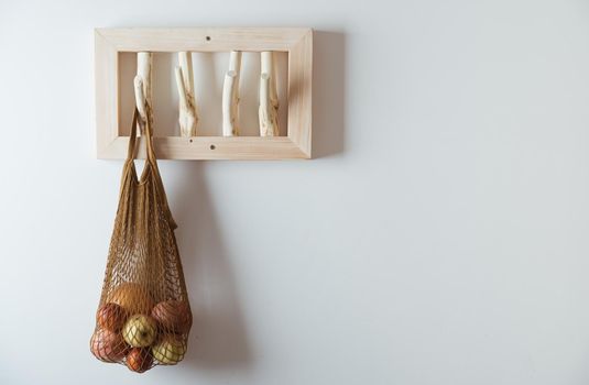 straw bag on handmade wooden hang. Concept of slowlife home. High quality photo