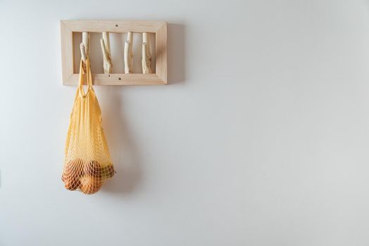 straw bag on handmade wooden hang. Concept of slowlife home. High quality photo