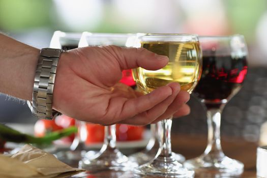 Close-up of male person take glass of alcoholic drink from bar, cooling beverage, champagne or wine. Get drunk, celebrate with drink, cheers, toast concept