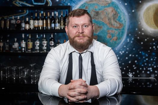 Bearded Adult Caucasian Looking Professional Bartender Portrait in Nightclub.