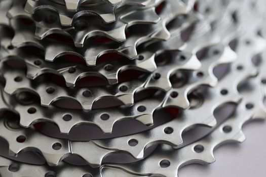 Close-up of bicycle roller chain, part of vehicle that transfer power from pedals to drive. Rear cassette in mountain bike, metal detail. Transport concept