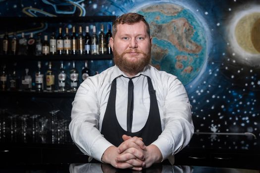 Bearded Adult Caucasian Looking Professional Bartender Portrait in Nightclub.