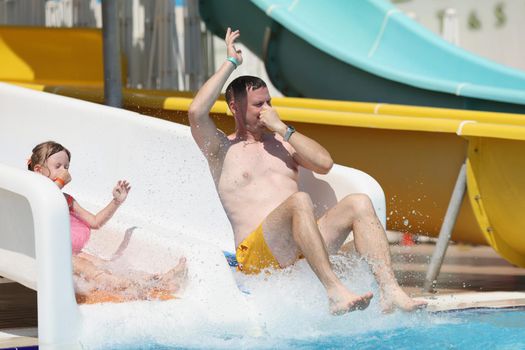 Portrait of man father enjoy sliding at water park, summer vacation, go nuts on travel trip. Person laugh, enjoy holiday. Summertime, water fun concept