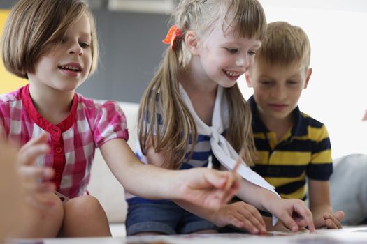 Portrait of happy kids playing card game at home, children party, birthday celebration. Pastime for children and development. Childhood, holiday concept