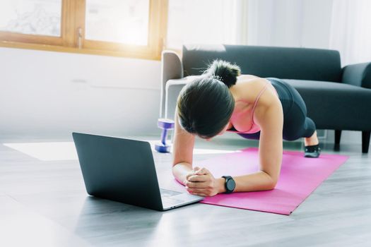 stress relief, muscle relaxation, breathing exercises, exercise, meditation, portrait of Young Asian woman relaxing her body from office work by practicing yoga by watching online tutorials