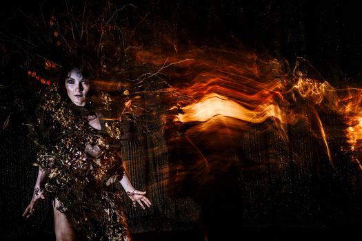 Ghost girl, the Spirit of the theater, accompanied by a trail of fire, on the stage of the theater.