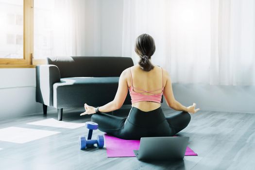 stress relief, muscle relaxation, breathing exercises, exercise, meditation, portrait of Young Asian woman relaxing her body from office work by practicing yoga by watching online tutorials