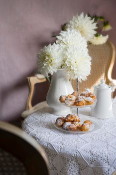 tea break in english style, vintage retro still life, homemade buns and a bouquet of white dalias. High quality photo
