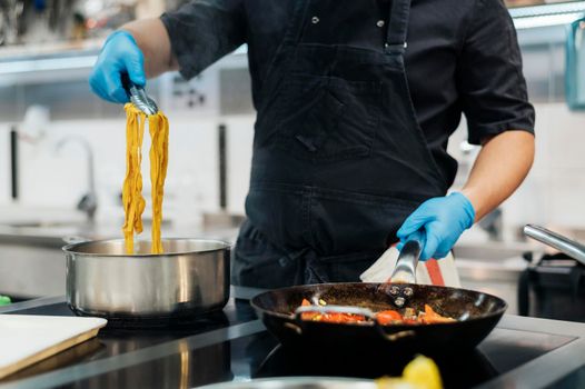 front view chef with gloves cooking pasta kitchen