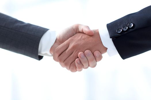 closeup.handshake of business partners on background of office