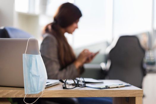 side view defocused businesswoman woman desk