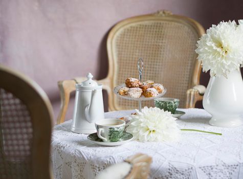 tea break in english style, vintage retro still life, homemade buns and a bouquet of white dalias. High quality photo