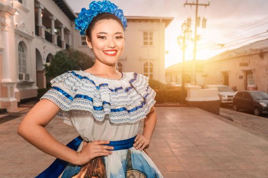 Traditional dancer from Nicaragua smiling and looking at camera at sunset wearing the typical costume of Central America, similar to used in Mexico, Honduras, El Salvador, Guatemala and South American