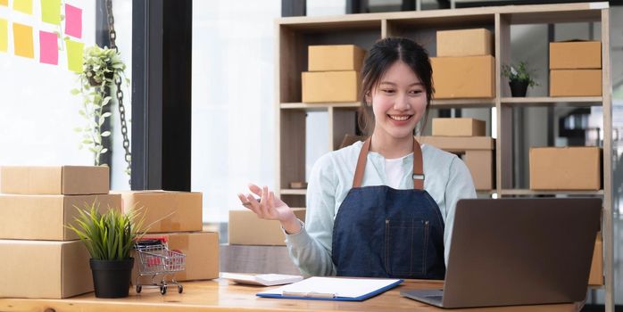 Portrait of Starting small businesses SME owners female entrepreneurs working on receipt box and check online orders to prepare to pack the boxes, sell to customers, SME business ideas online..