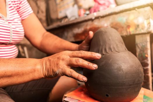Closeup of the hands of an artisan from La Paz Centro, Nicaragua, Central America, molding a piece of clay. Concept of work and culture in Latin America