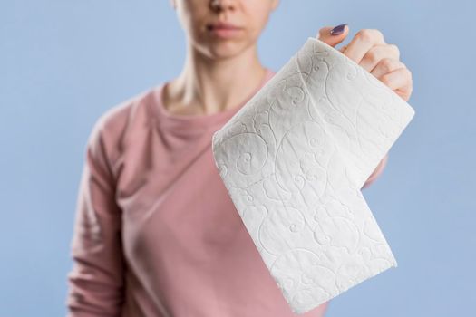 front view woman holding toilet paper roll